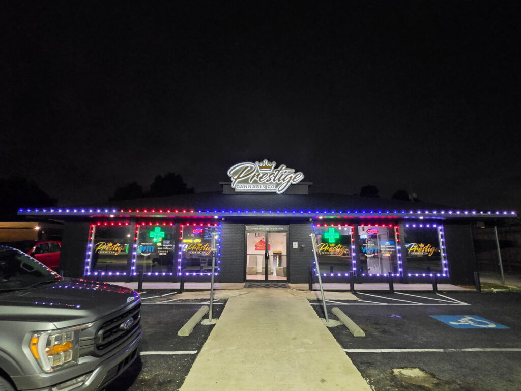 Commercial storefront outlined with RGB architectural lighting highlighting windows and roofline at night